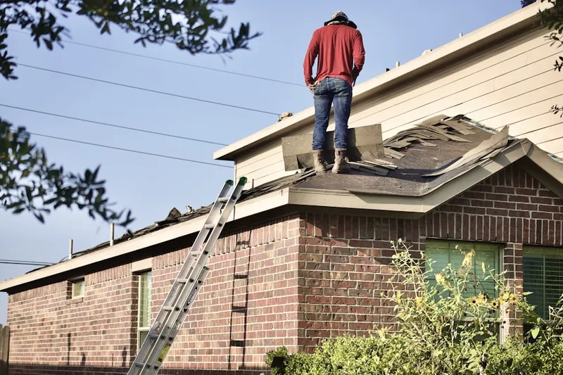 Professional roofer working on a residential roof in Beachwood Glen